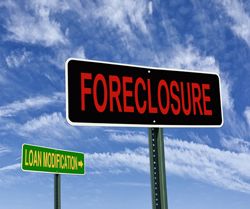 Road signs that say "Loan modification" and "Foreclosure"